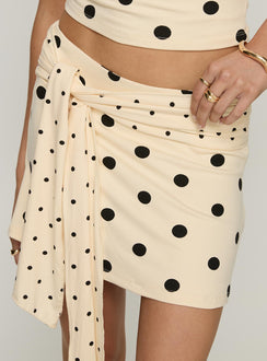 back view of model wearing Princess Polly Porzia Wrap Detail Mini Skirt Cream / Polka Dot Mini Skirts 