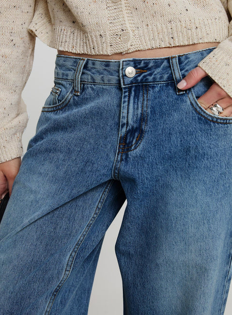 side view of model wearing Princess Polly Sabryna Low Rise Jeans Blue Low Rise Jeans 