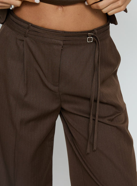 front view of model wearing Princess Polly Natilee Relaxed Tailored Pants Brown Pinstripe Low Rise Pants 