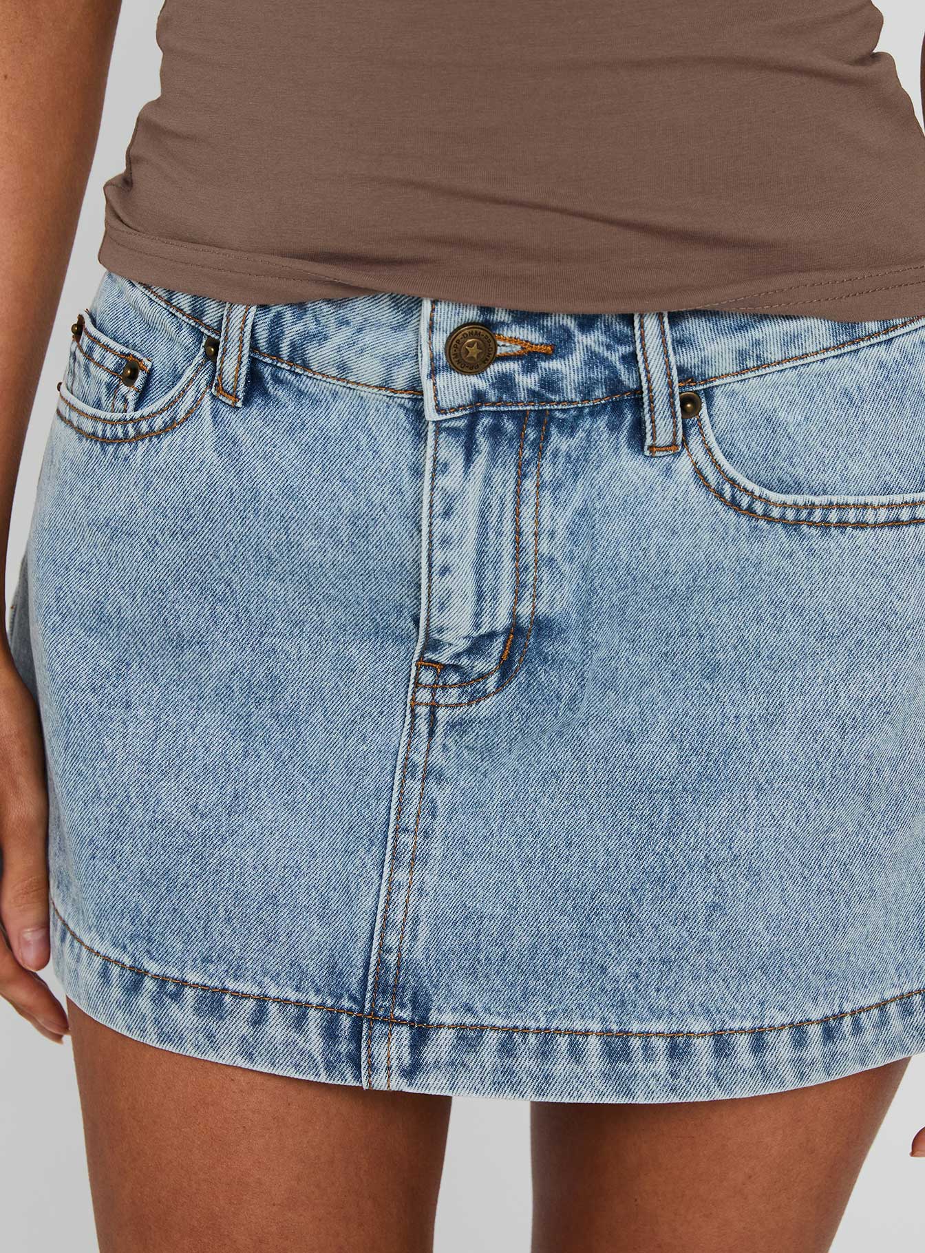 back view of model wearing Princess Polly Nicolina Low Rise Denim Mini Skirt Ice Blue Wash Tall Mini Skirts 