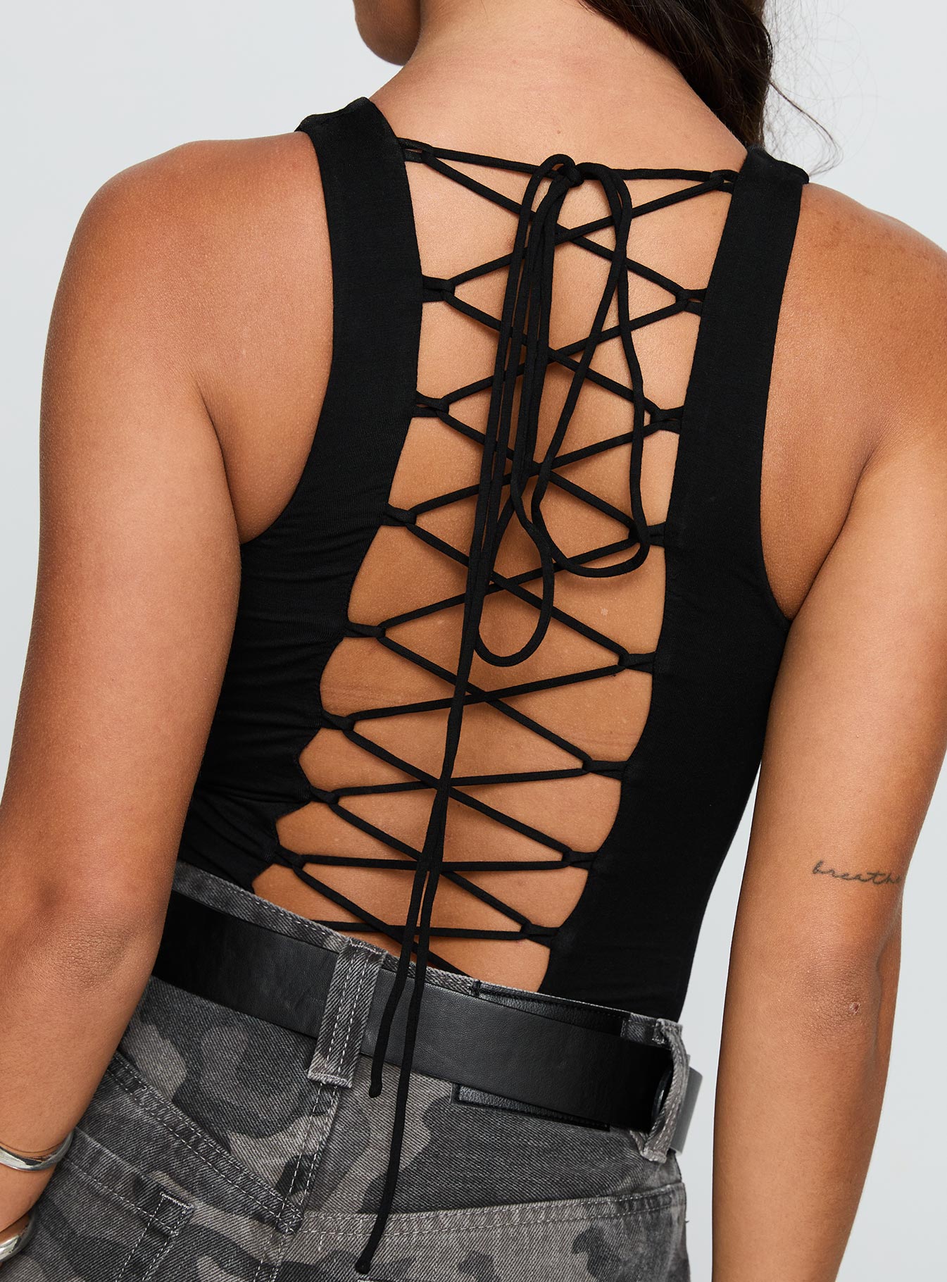 side view of model wearing Princess Polly Majesty Tie Back Bodysuit Black Sleeveless 