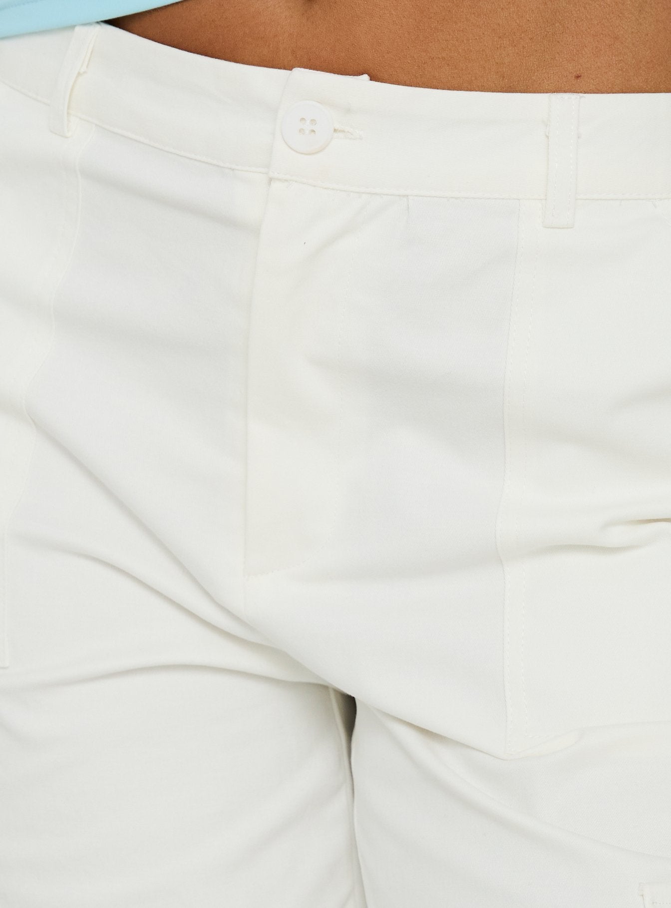 Featuring the Alfonza Utility Capri White womens-regular-pants in mid-rise cargo style front view of model wearing Princess Polly