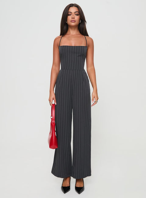 Jumpsuit fastening at back, invisible zip fastening, twin hip &amp; back pockets, partially exposed back, straight leg