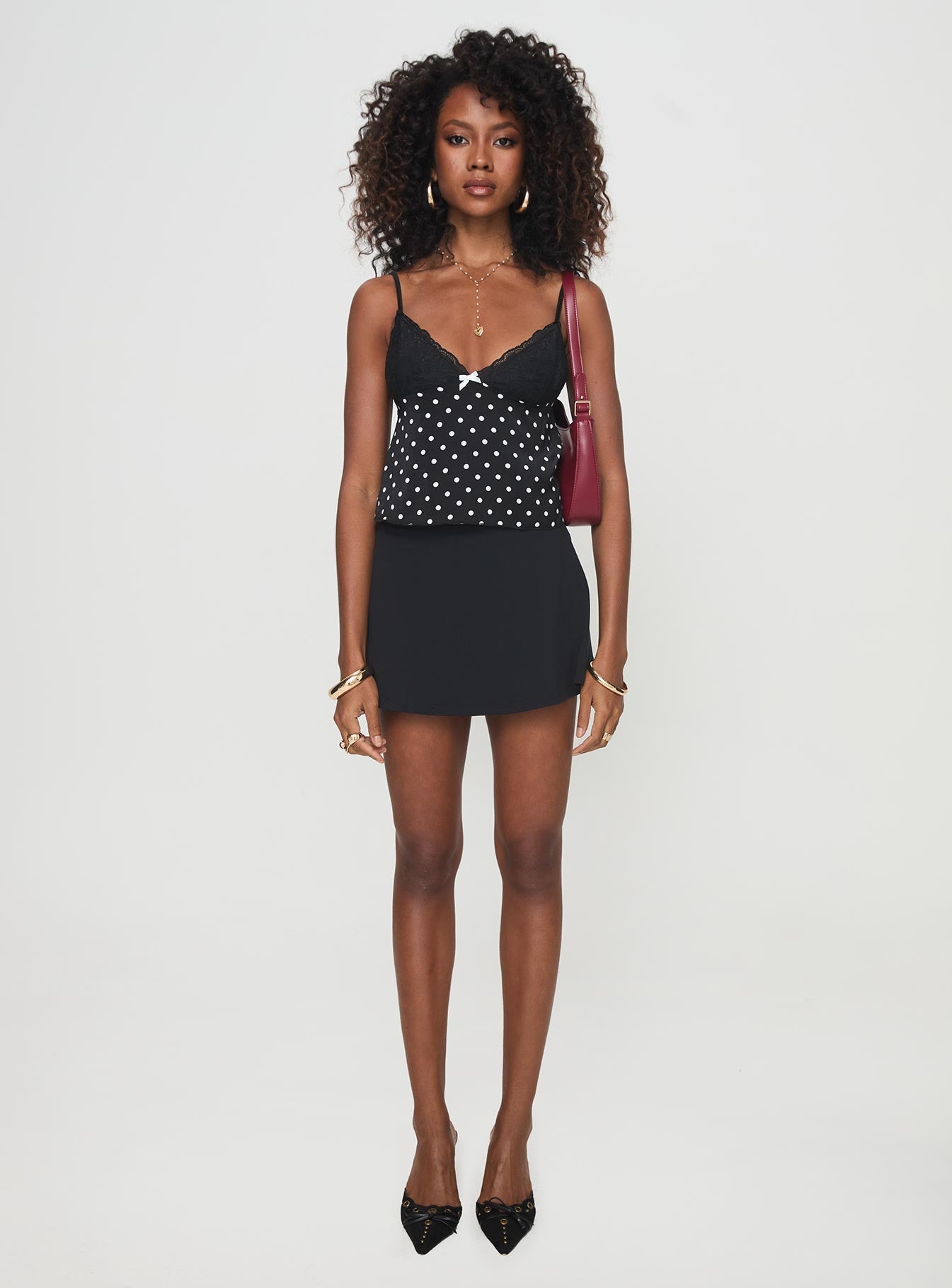 front view of model wearing Princess Polly Castien Top Black Polka Sleeveless Plunger 