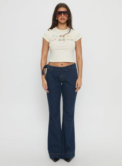 front view of model wearing Princess Polly Acapulco Low Rise Flare Jeans Dark Blue Wash Low Rise Jeans 