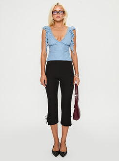 side view of model wearing Princess Polly Miztry Top Blue Polka Sleeveless Plunger 