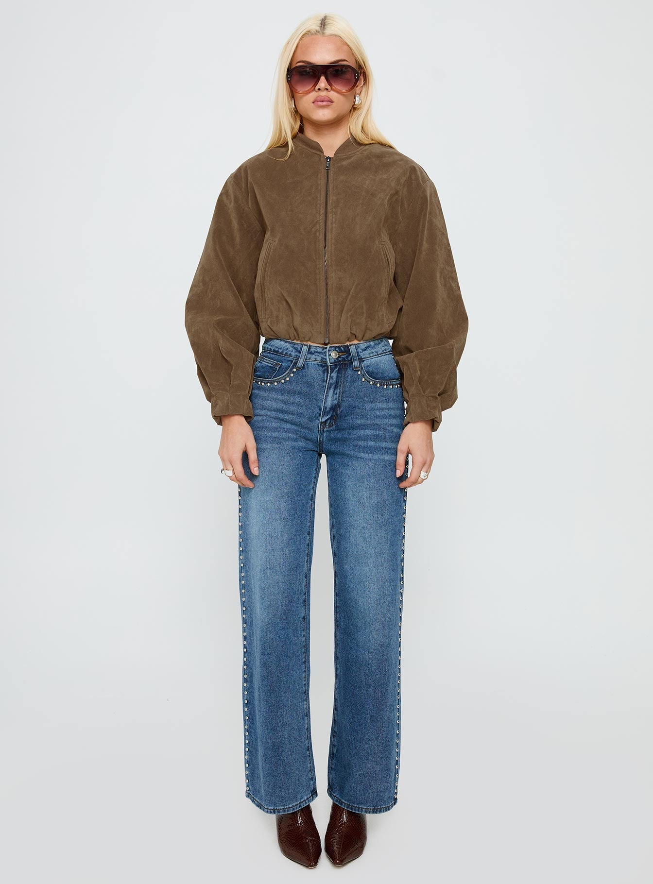 side view of model wearing Princess Polly Saving Up Stud Detail Jeans Mid Blue Mid Rise 