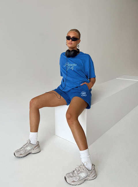 Front view of model wearing  front Princess Polly Three Fourth Sleeves Crew Neck  Princess Polly Cursive Oversized Tee Blue / White