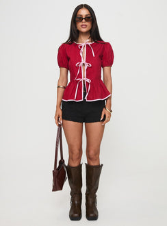 side view of model wearing Princess Polly Ryota Blouse Red/pink Short Sleeves Crew Neck 