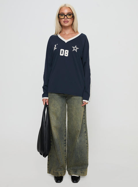 side view of model wearing Princess Polly Spectate Top Long Sleeve Navy Full Sleeves V-Neck 