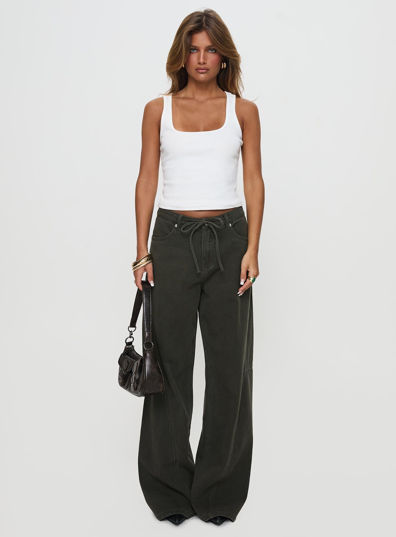 front view of model wearing Princess Polly Bruiser Tie Waist Mid Rise Wide Leg Jeans Green Petite High Rise Jeans 