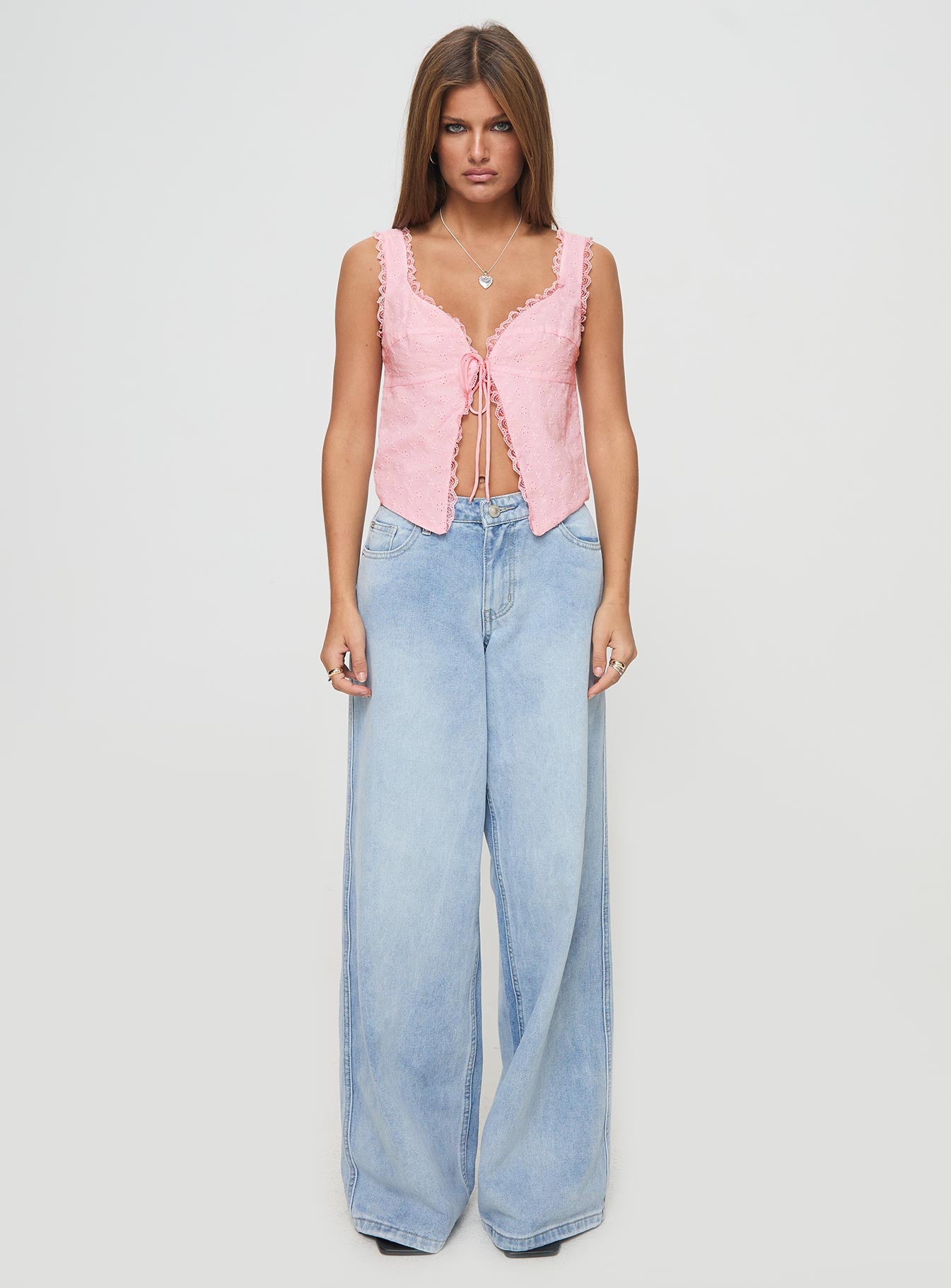 back view of model wearing Princess Polly Merrelle Top Pink Sleeveless Plunger 