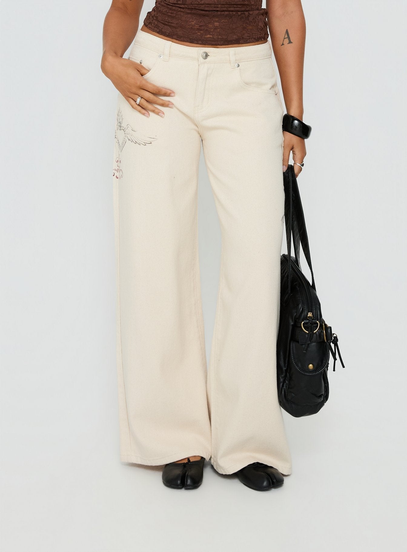 front view of model wearing Princess Polly Than Forever Love Graphic Denim Jeans Cream Low Rise Jeans Jeans 