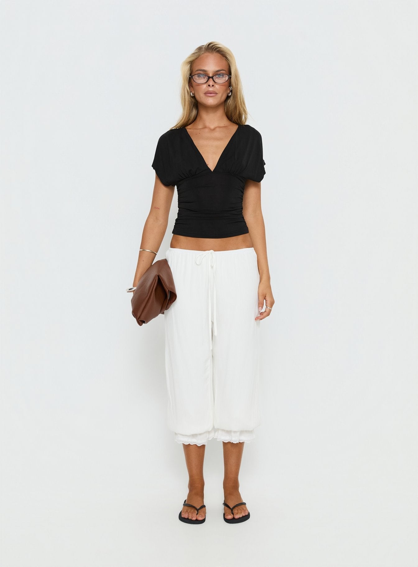 side view of model wearing Princess Polly Basma Bloomer Trouser Pants Rayon White Mid Rise Pants 