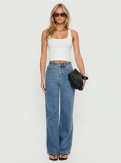 front view of model wearing Princess Polly Thearlie High Rise Flared Jeans Mid Blue Wash High Rise Jeans 