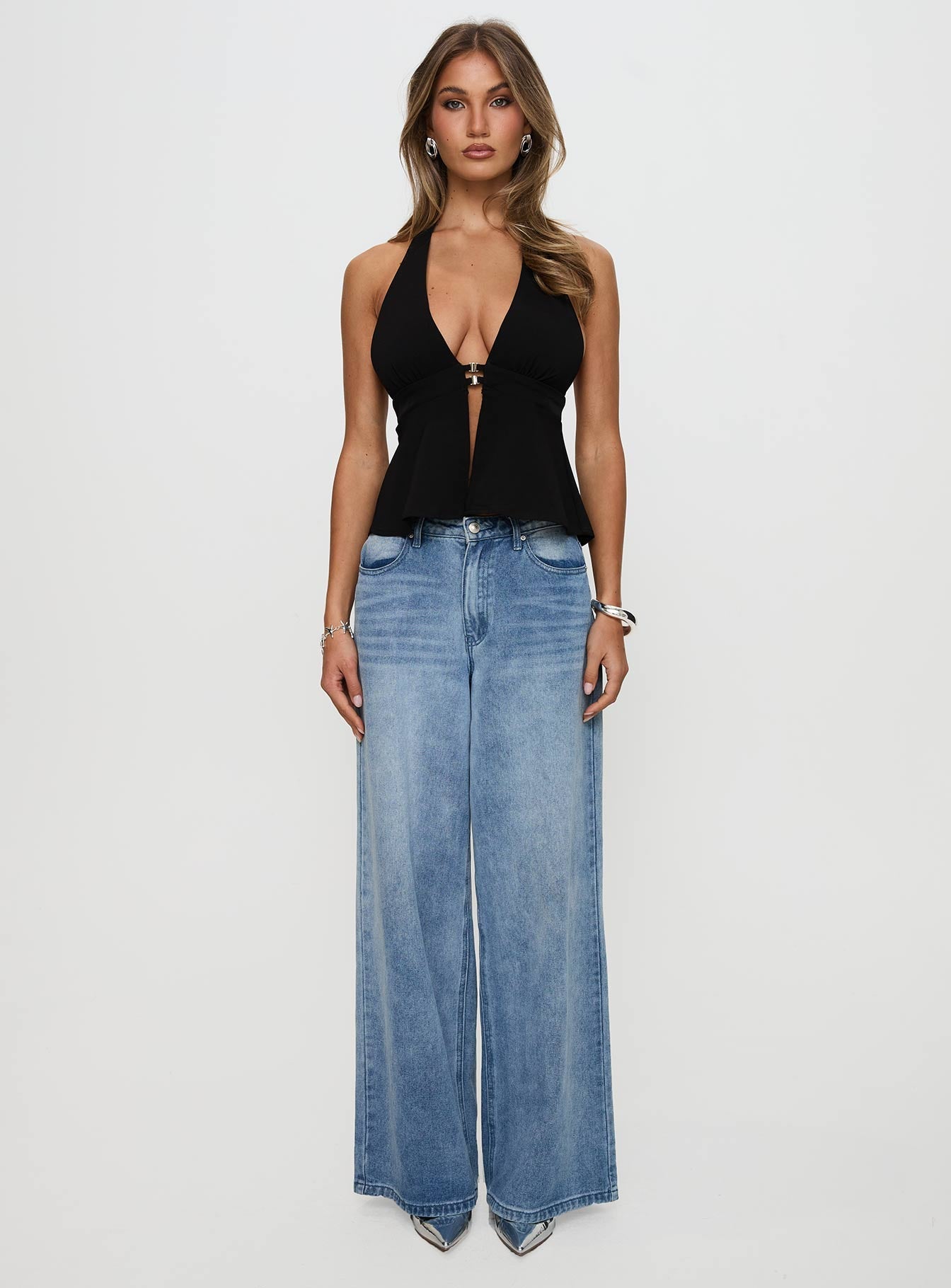 side view of model wearing Princess Polly Brealle Halter Top Black Sleeveless Plunger 