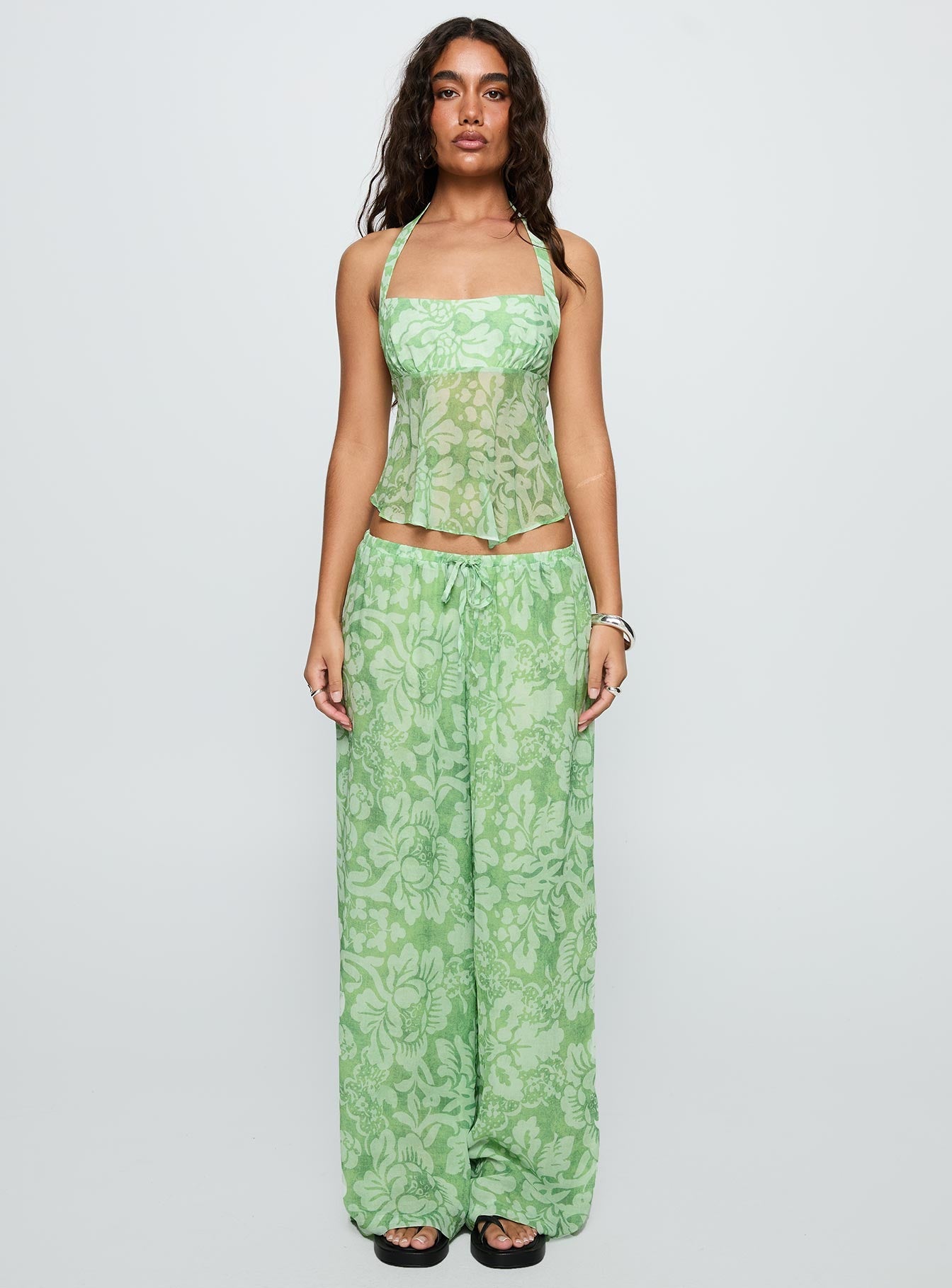 side view of model wearing Princess Polly Finesse Pants Green Floral High Waisted Pants 