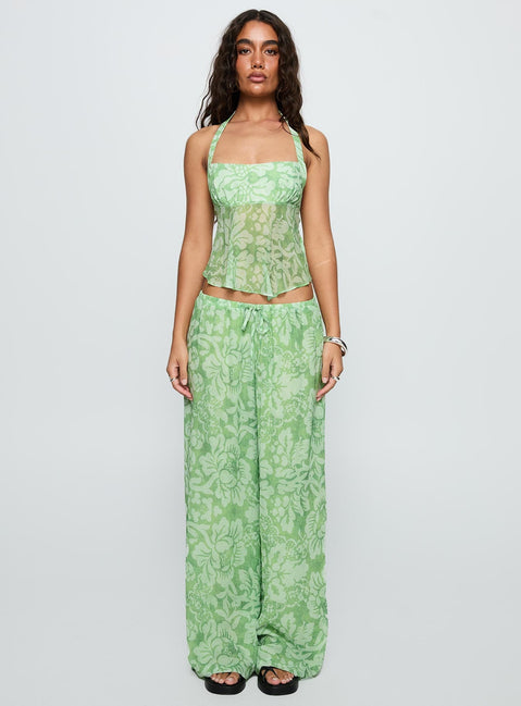 side view of model wearing Princess Polly Finesse Pants Green Floral High Waisted Pants 