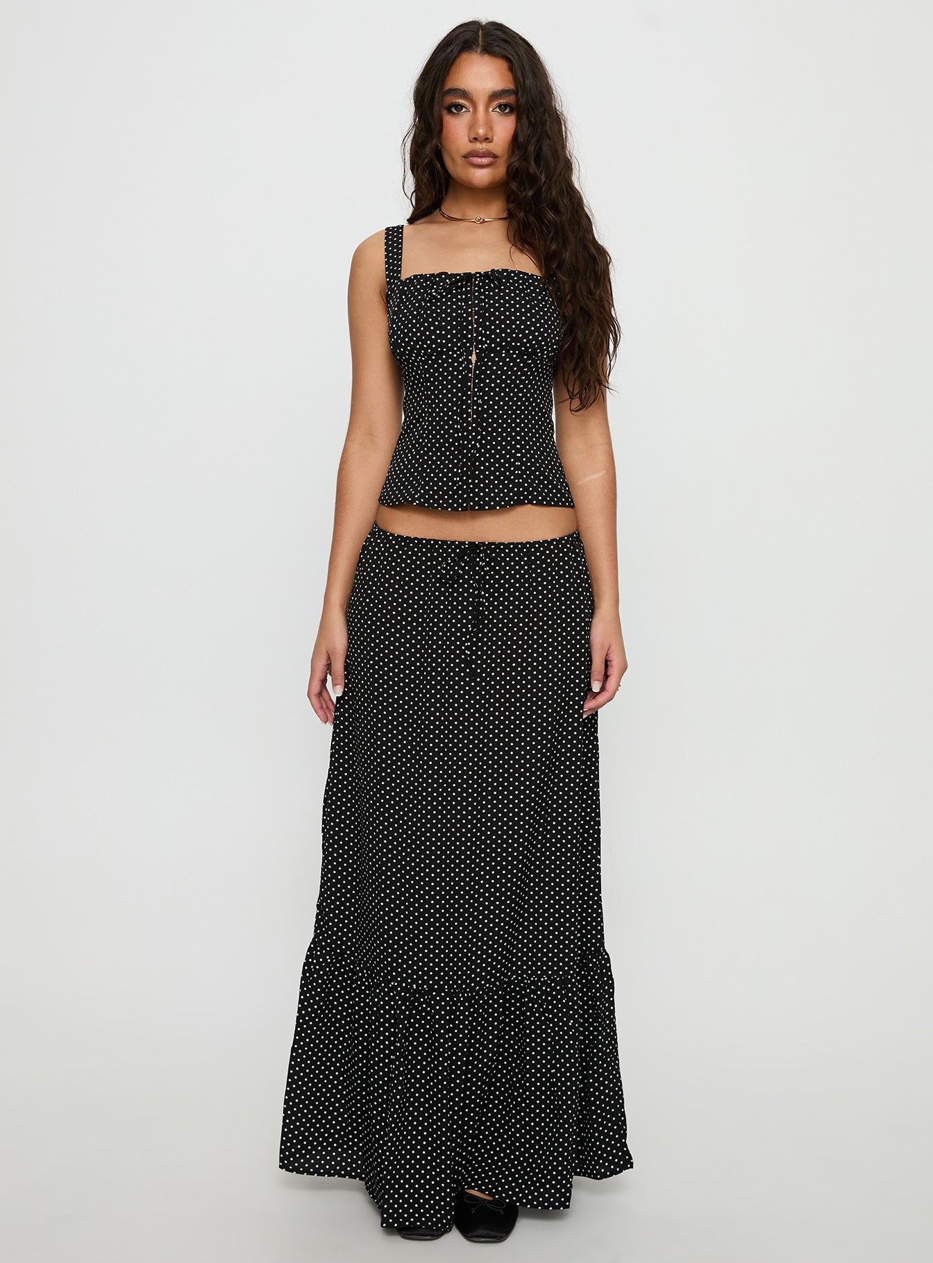   side view of model wearing Princess Polly Modern Girl Maxi Skirt Black / Polka Dot 