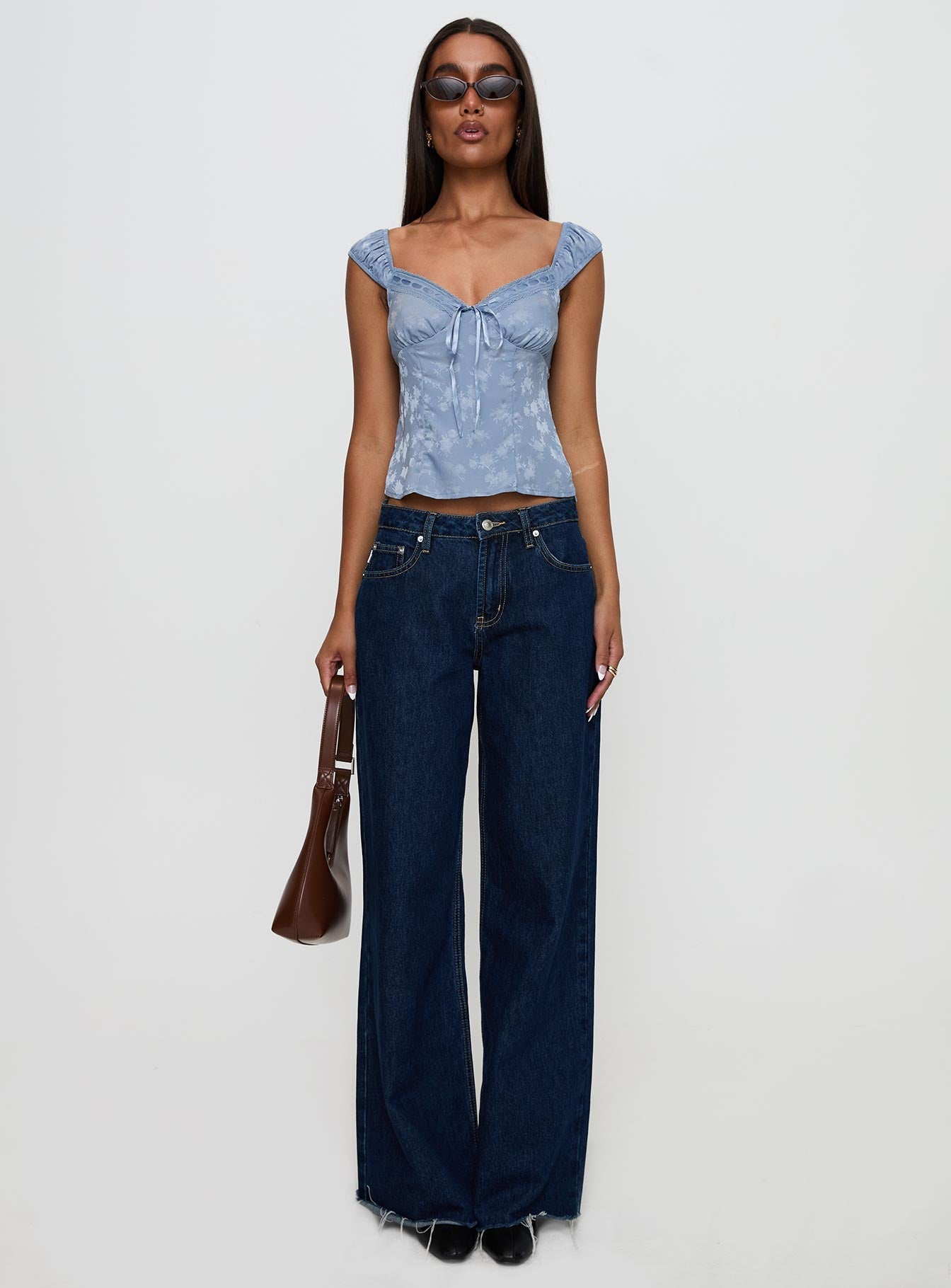 front view of model wearing Princess Polly Branwen Cap Sleeve Tie Detail Top Blue Floral Sleeveless Sweetheart 