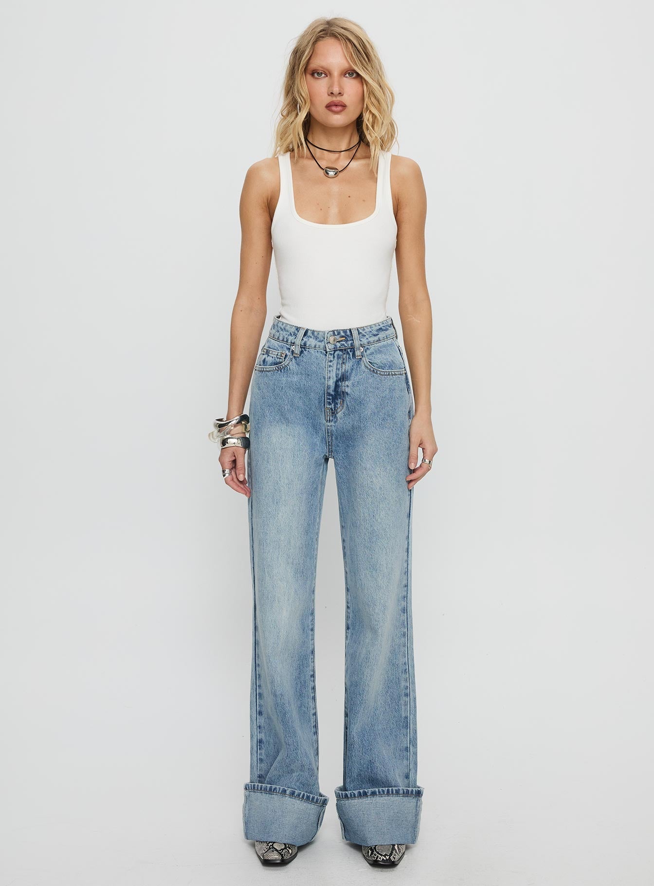 side view of model wearing Princess Polly Florida Keys Mid Rise Straight Leg Cuffed Jeans Light Blue Wash High Waisted Jeans 