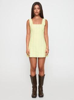 side view of model wearing Princess Polly Dasha Mini Dress Lemon Square Neck 