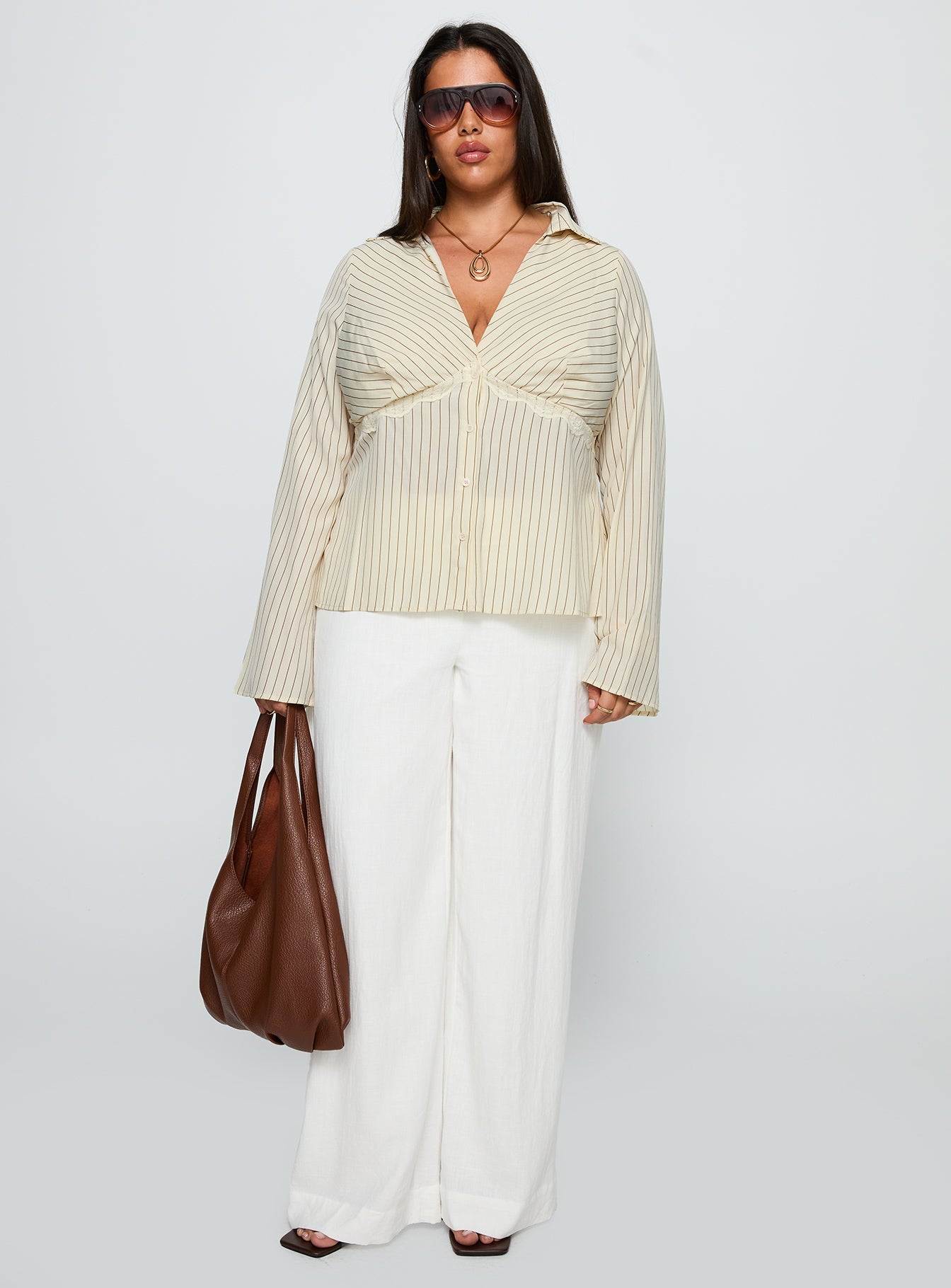 side view of model wearing Princess Polly Life Begins Long Sleeve Lace Trim Top Cream Stripe Curve Full Sleeves Plunger 