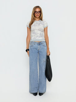 side view of model wearing Princess Polly Candi Mid Rise Wide Leg Studded Jeans Light Blue Wash Mid Rise Jeans 