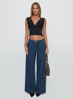 front view of model wearing Princess Polly Ramos Low Rise Denim Jeans Dark Blue Wash Low Rise Jeans 