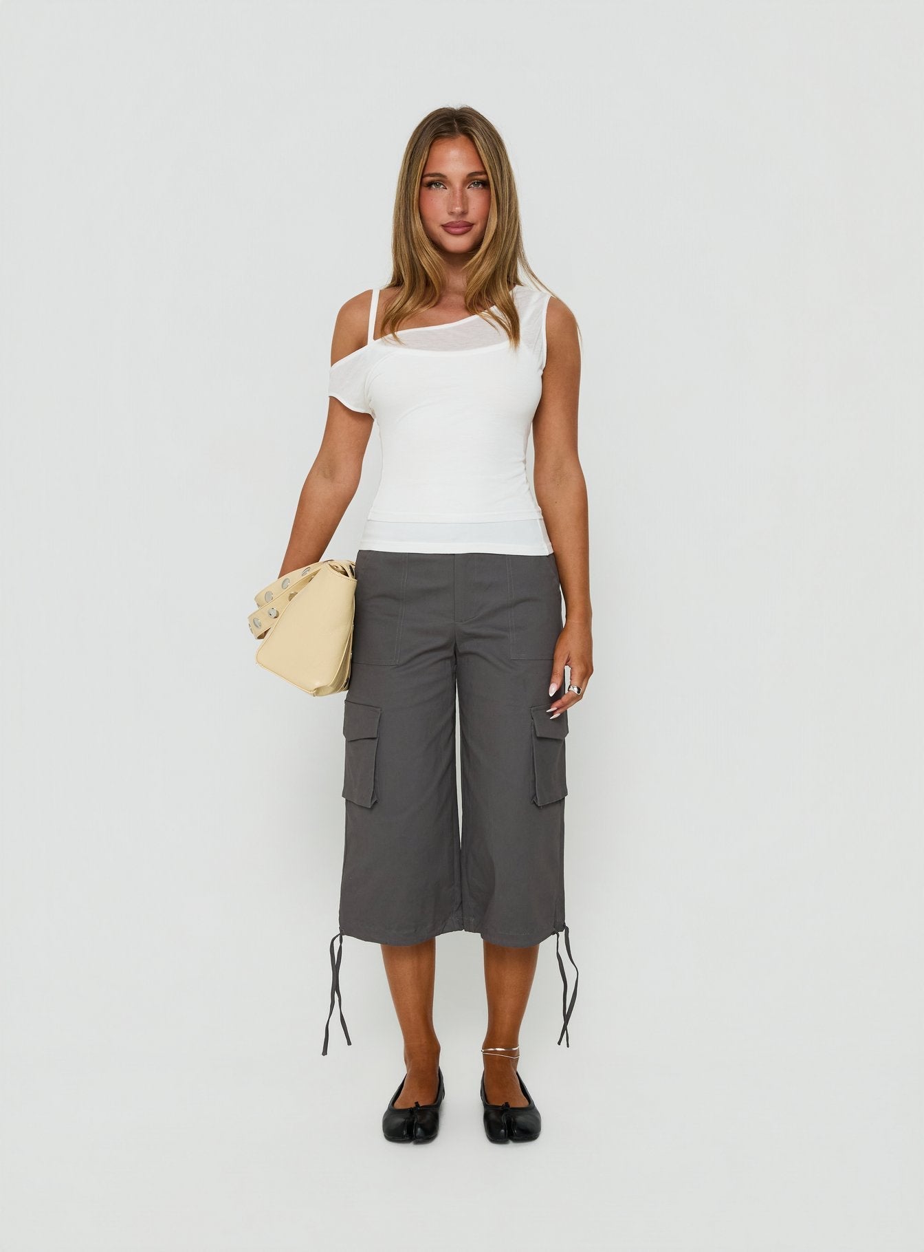 Featuring the Alfonza Utility Capri in Slate womens-regular-pants with mid-rise cargo styling front view of model wearing Princess Polly