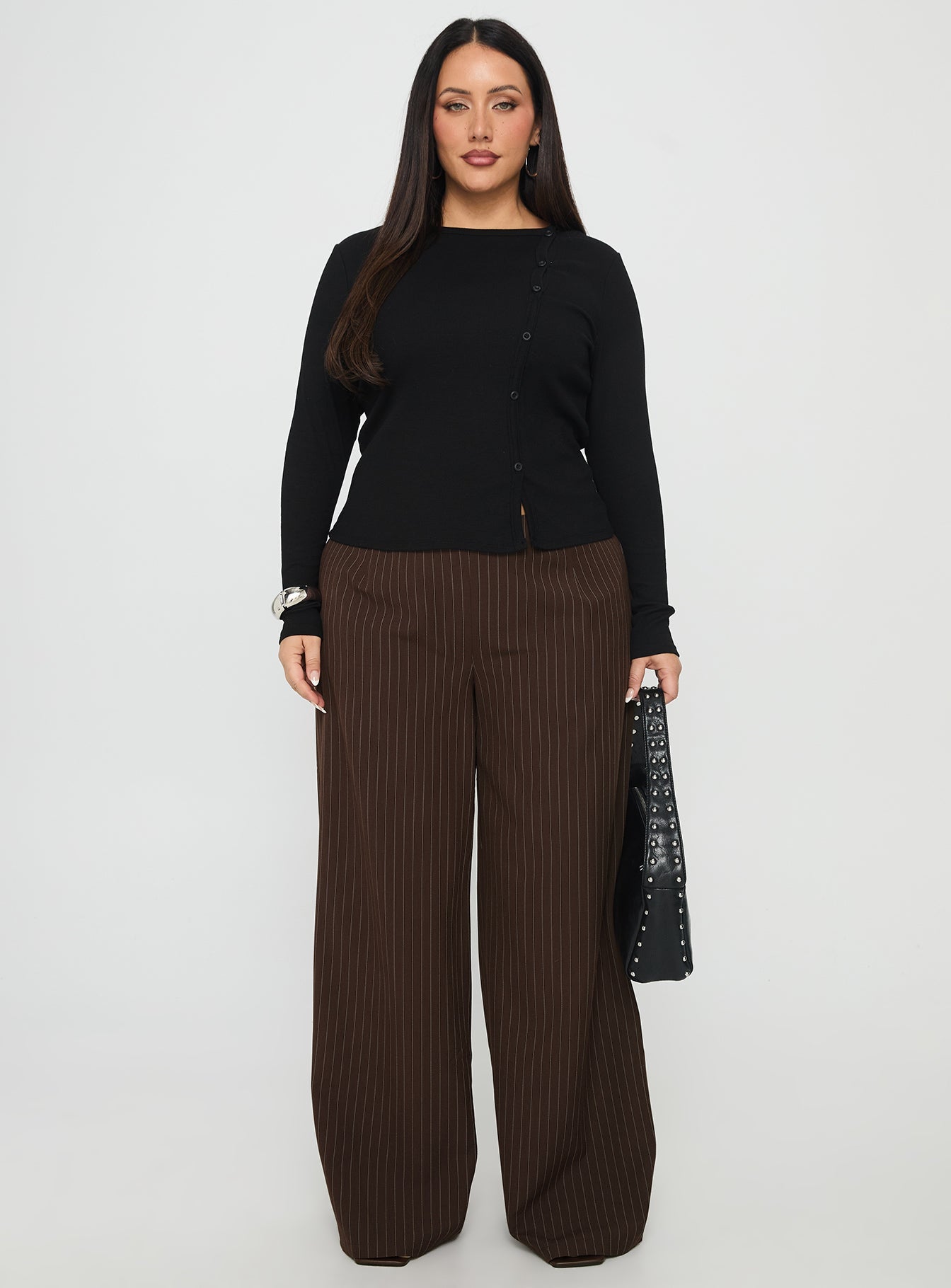 side view of model wearing Princess Polly Khane Low Rise Wide Leg Pant Brown Pinstripe Curve Low Rise Pants 