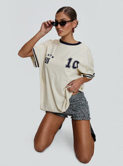 side view of model wearing Princess Polly Cornwall Football Jersey Cream Half Sleeves Crew Neck 