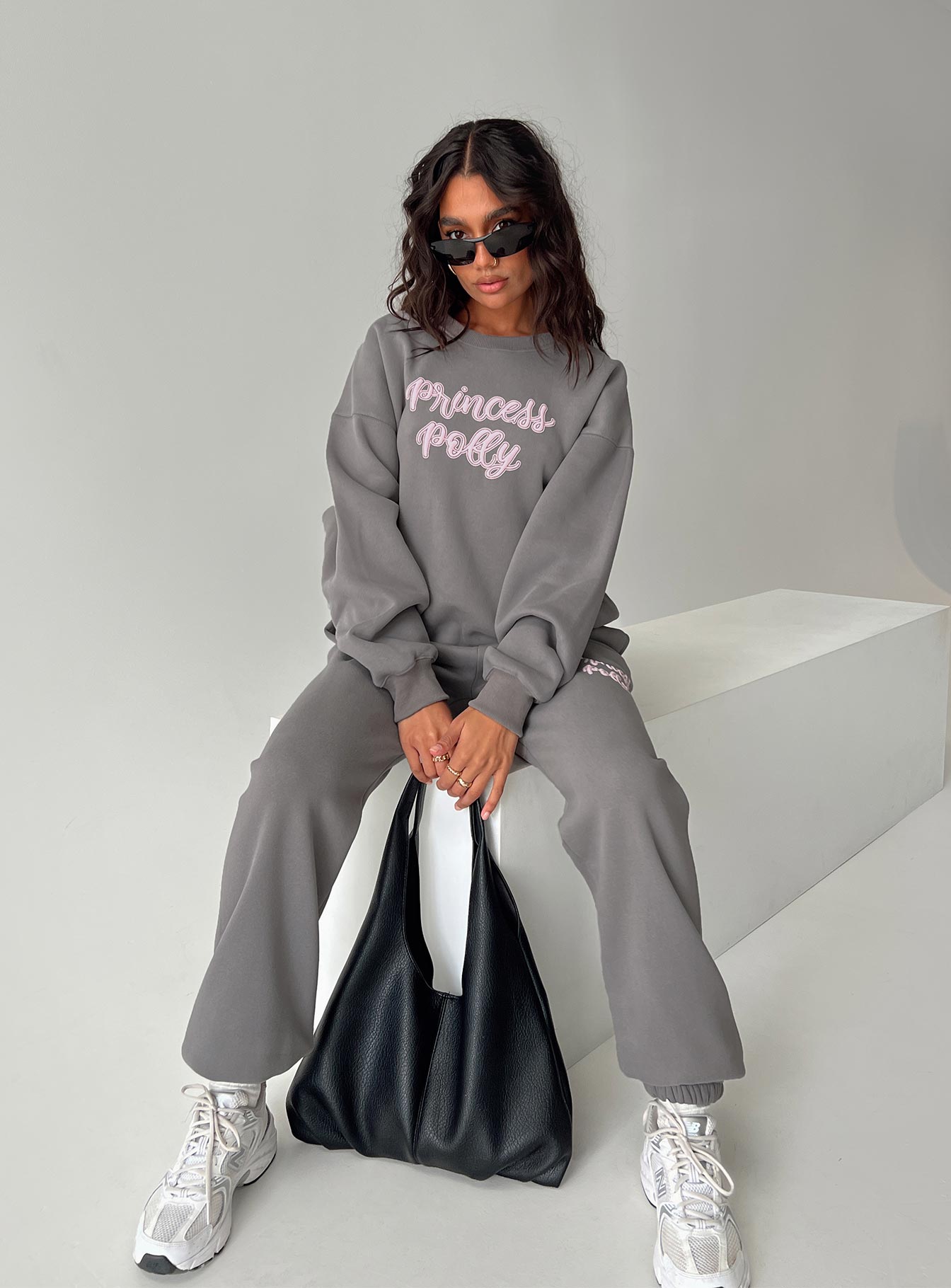 side view of model wearing Princess Polly Princess Polly Crew Neck Sweatshirt Puff Text Charcoal Long 