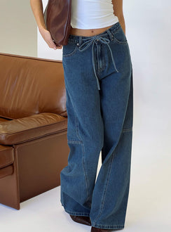 side view of model wearing Princess Polly Bruiser Mid Rise Wide Leg Jeans Mid Blue Wash Mid Rise Jeans 