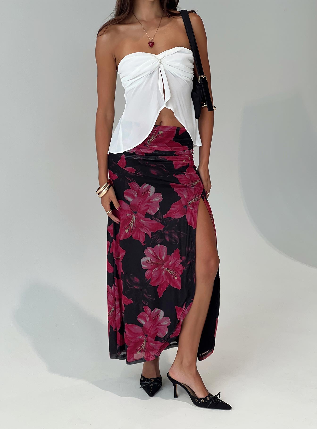   side view of model wearing Princess Polly Cooperi Maxi Skirt Black / Red Floral Maxi 