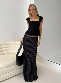   side view of model wearing Princess Polly Ford Maxi Skirt Onyx Polka Maxi 