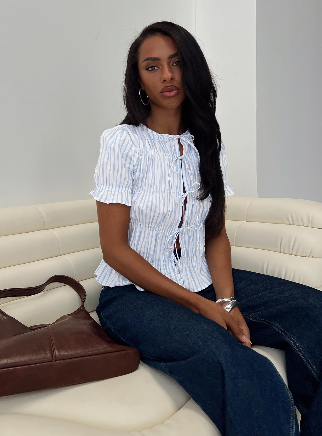 front view of model wearing Princess Polly Alistair Bow Tie Top Blue / White Stripe Short Sleeves Crew Neck 