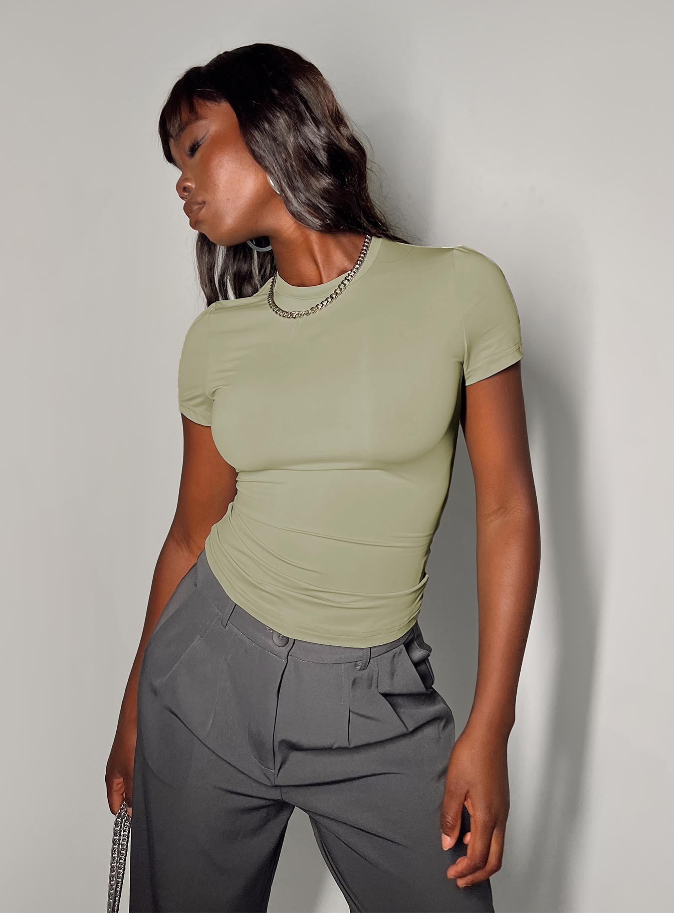 Front view of model wearing  front Princess Polly Short Sleeves High Neck  Lowell Top Green
