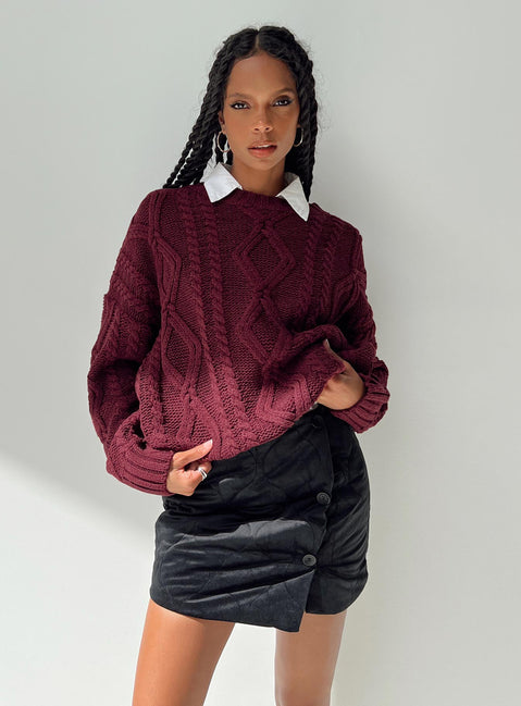 Black mini skirt Quilted material High rise Invisible zip fastening at back Button detail at front