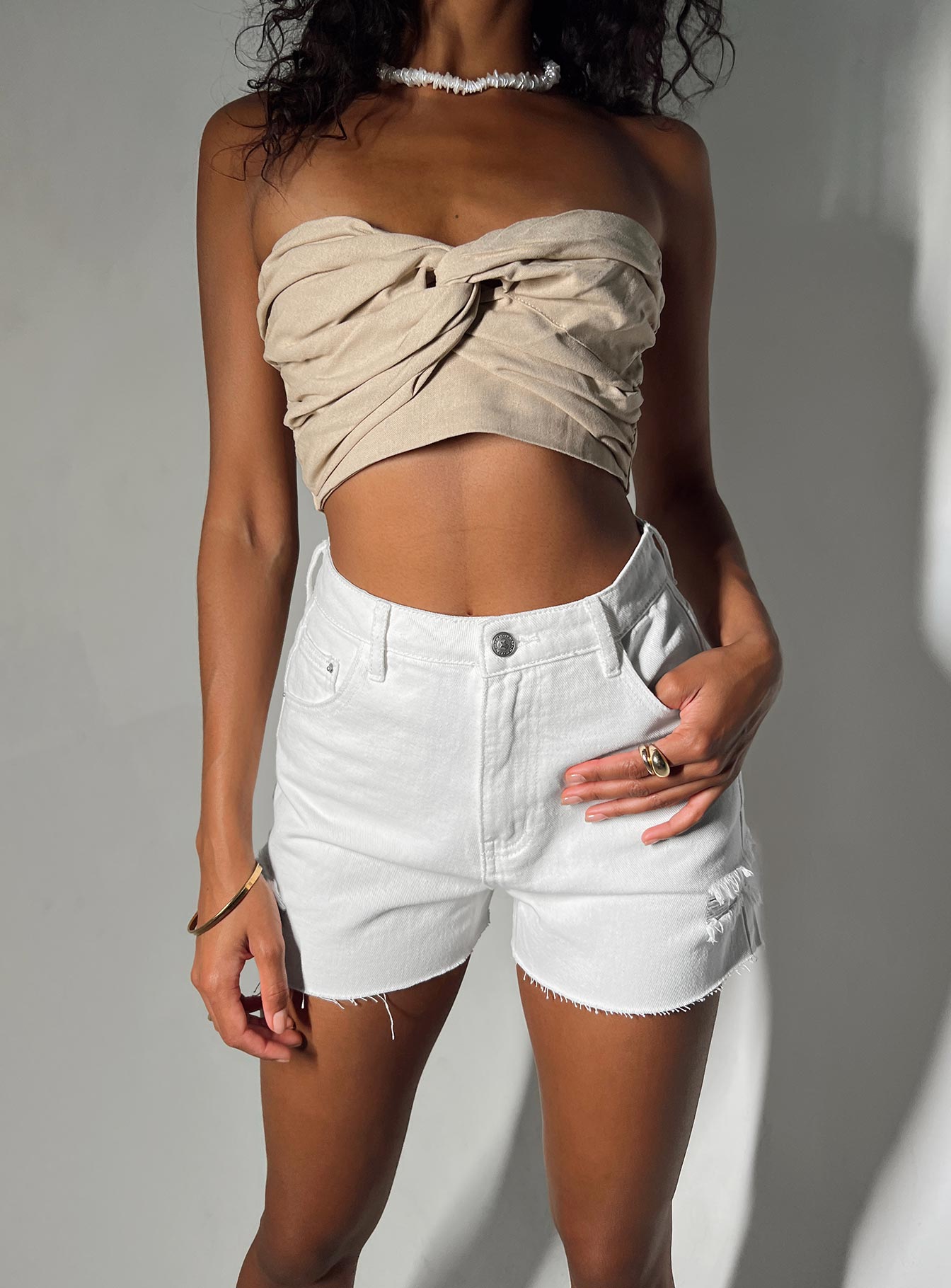 Denim shorts High waisted Belt looped waist Classic five pocket design Button & zip fastening Distressed detail on leg Raw cut hem 