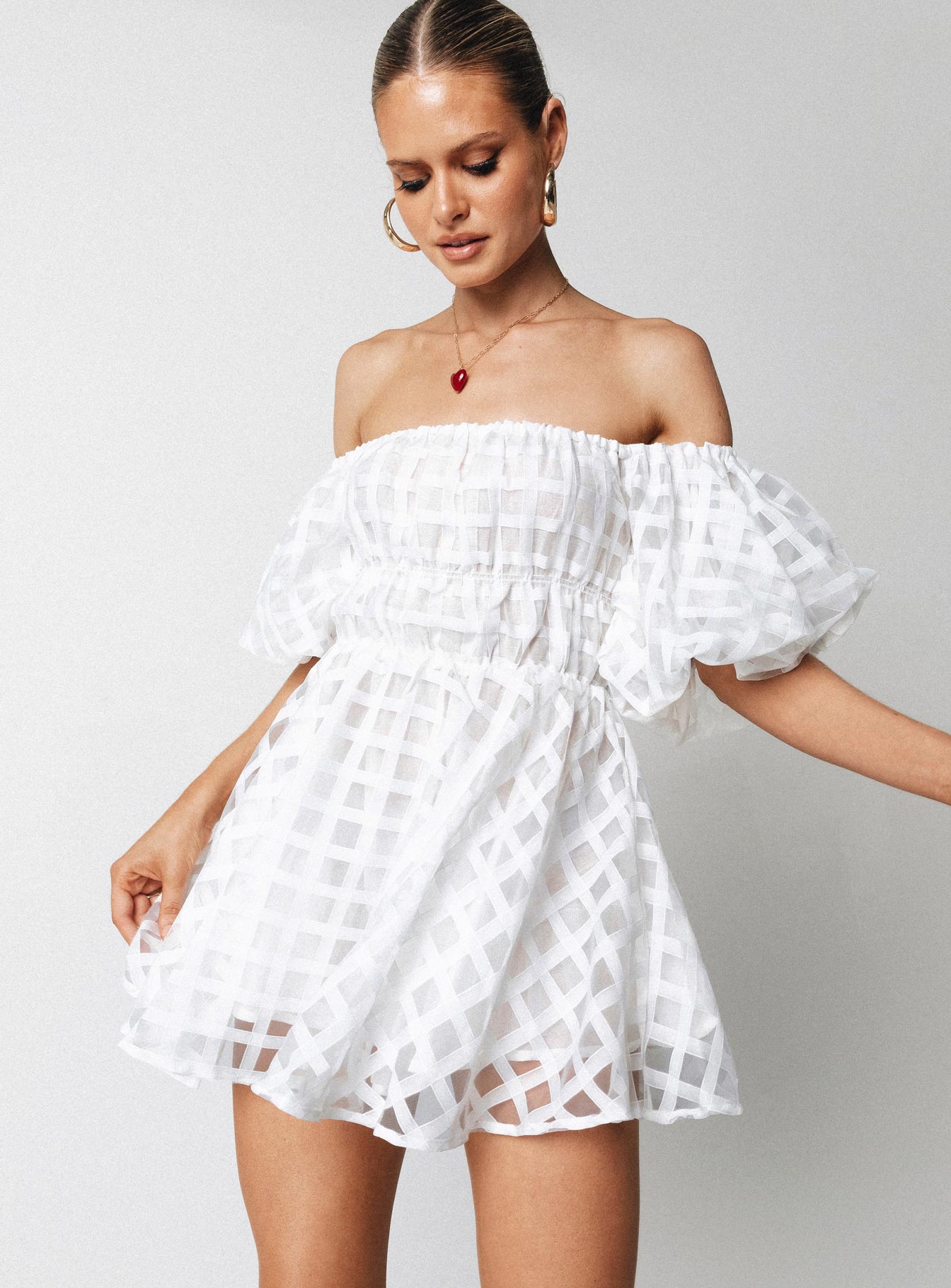 White mini dress Sheer material Off the shoulder design Puff sleeve Elasticated bands at waist
