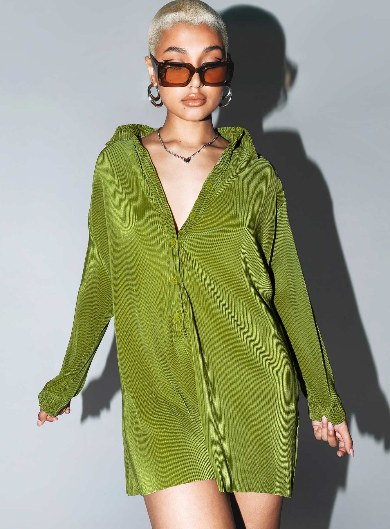 Green romper Silky material  Pleated design  Classic collar  Button front fastening  Drop shoulder  Button fastening at cuffs Raw cut hem 