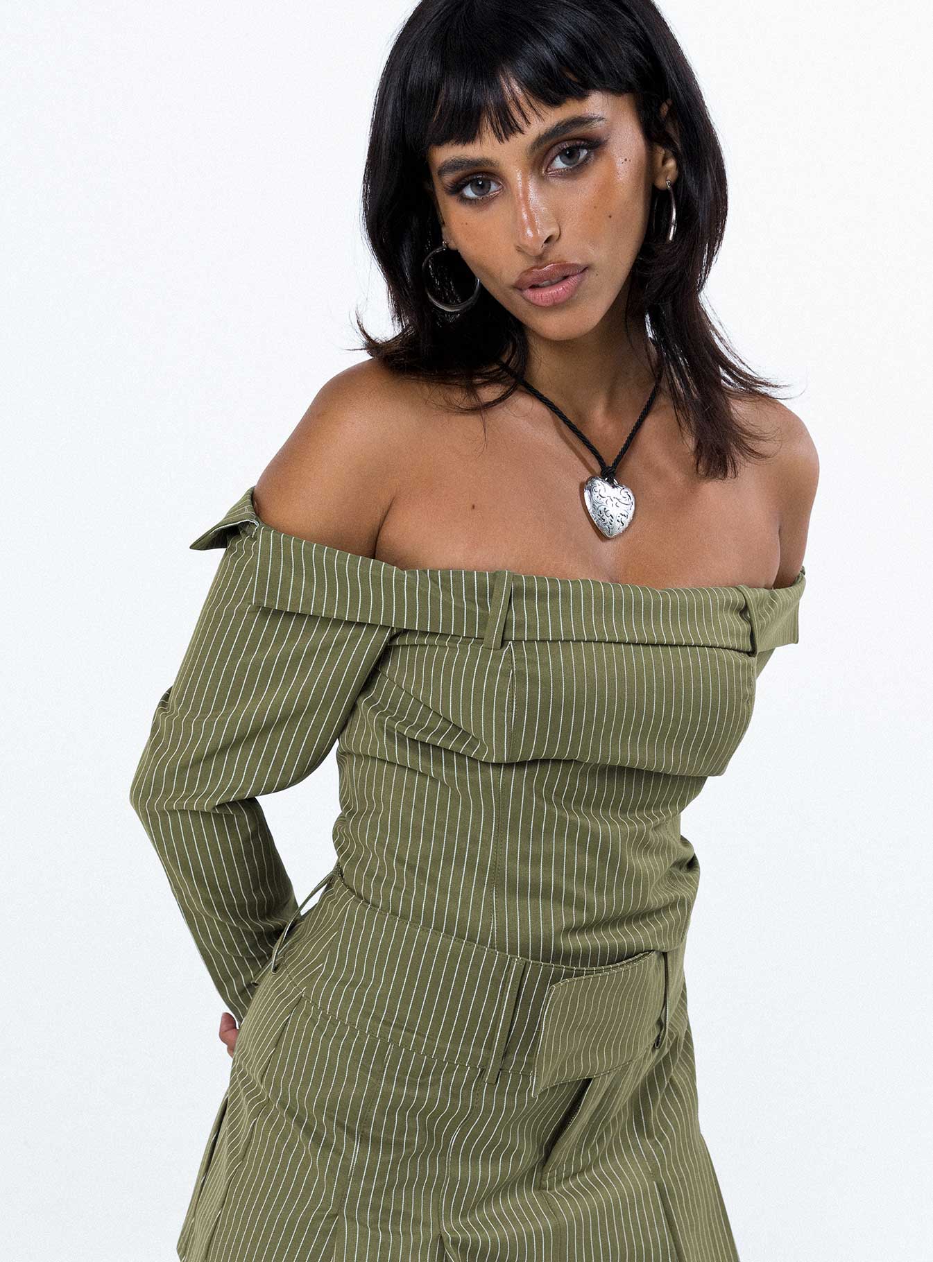 Green long sleeve top Pinstripe print Inner silicone strip at bust Folded neckline Zip fastening at back
