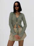 Long sleeve top 100% polyester  Sheer material  V neckline  Double tie front fastening 