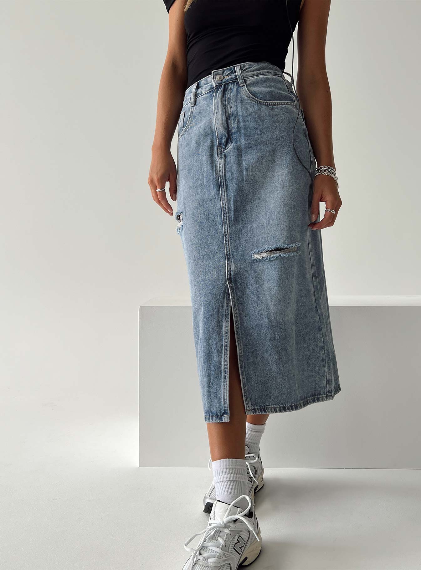 Midi skirt Light wash denim  Belt looped waist Zip and button fastening  Classic five pocket design Distressed detail Spilt hem