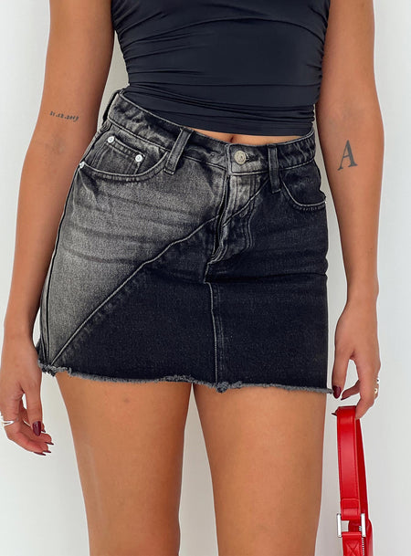 Denim mini skirt A-line style, classic five pocket design, zip and button fastening, belt loops at waist, raw edge hem, branded patch at back