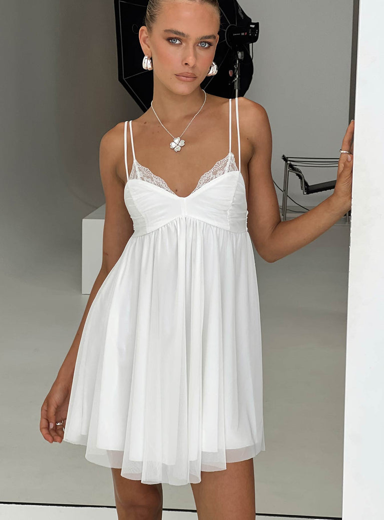 White Mini dress V neckline, dual adjustable straps, mesh material, ruching & lace trim detail on bust, raw edge hem