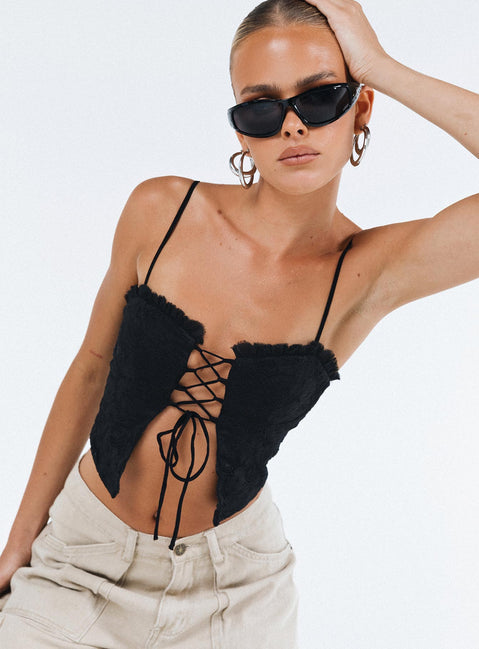 Crop top Lace material  Ruffle neckline  Adjustable shoulder straps  Inner silicone strip at bust  Lace up fastening at front Non stretch Fully lined 