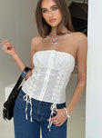 Strapless top Inner silicone strip at bust, criss-cross detail, button fastening Non-stretch material, lined bust