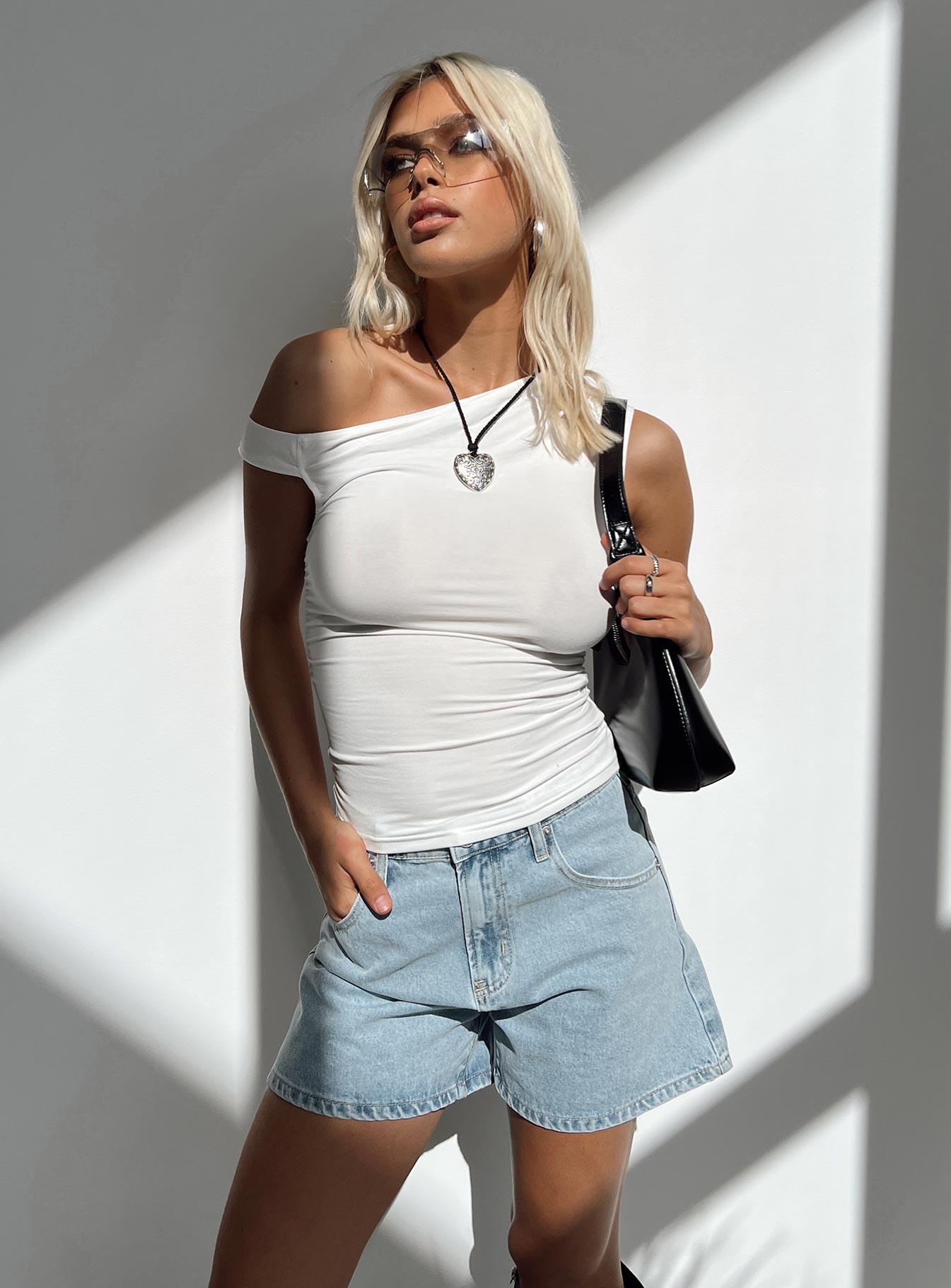 Denim shorts High rise Light wash denim Belt looped waist Zip and button fastening Five-pocket design Branded patch at back